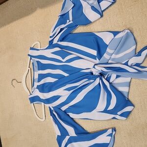 Blue and White blouse. Cut out shoulders bell sleeve. Tie front.